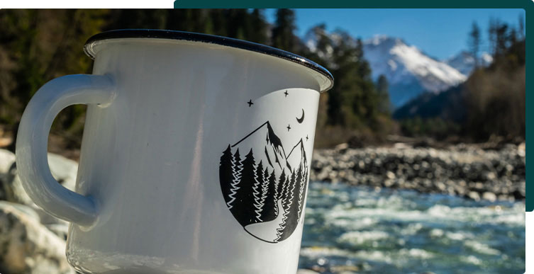 close up on metal mug by a river